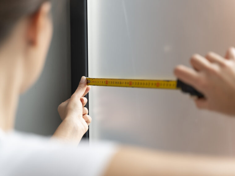 Man som mäter fönster